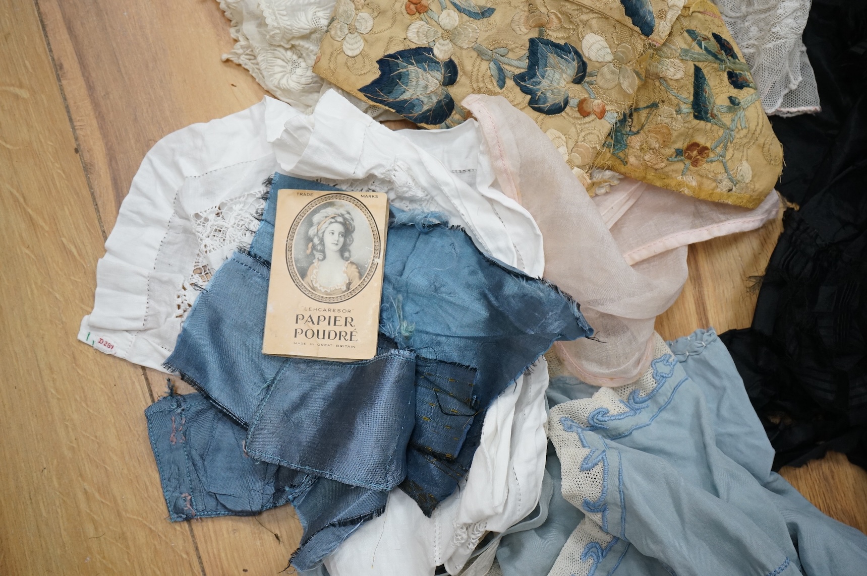 A collection of 19th century fabric and clothing, including a woven Paisley shawl, good for film and TV costume dramas